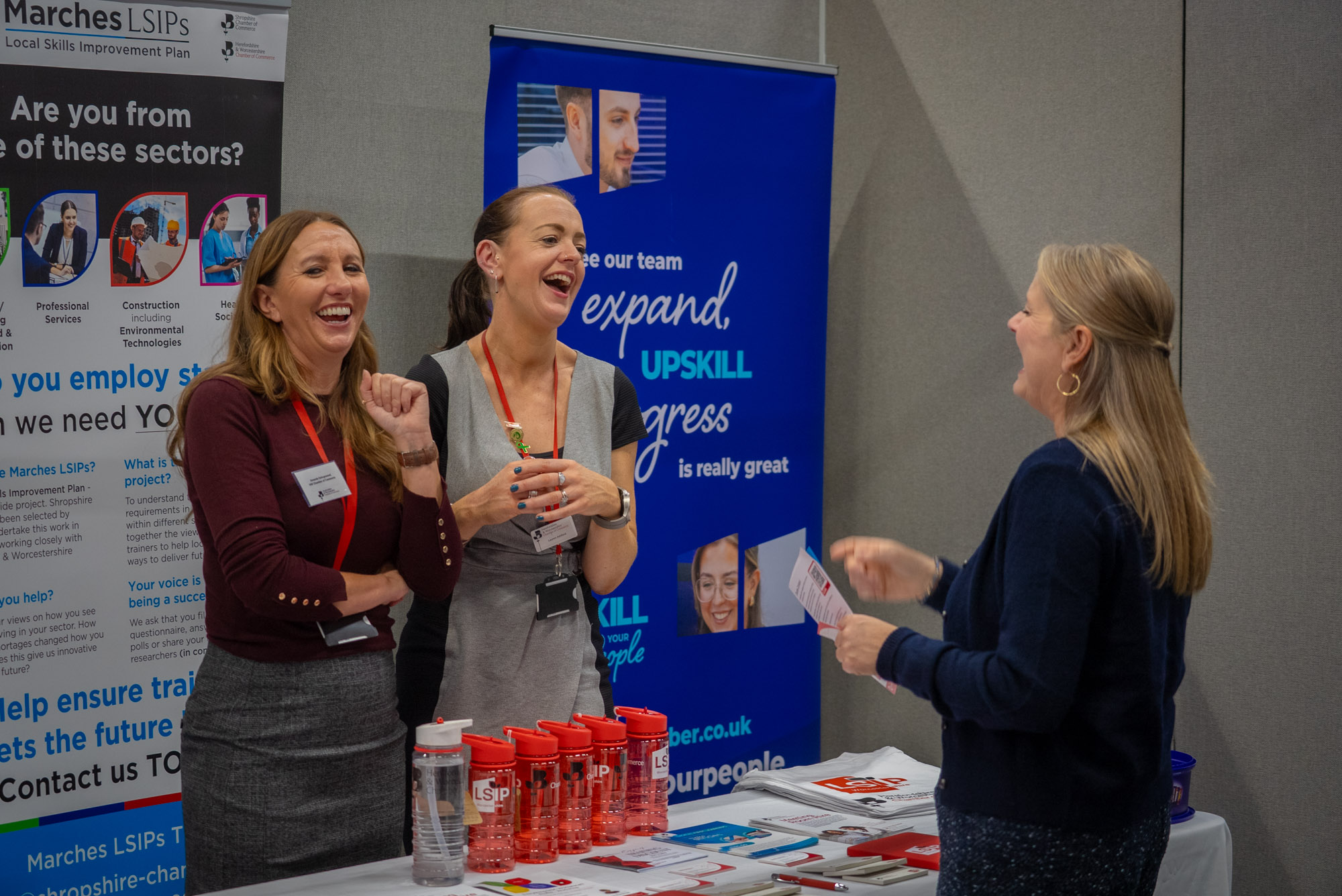 two men in building yard with hard hats, shaking hands