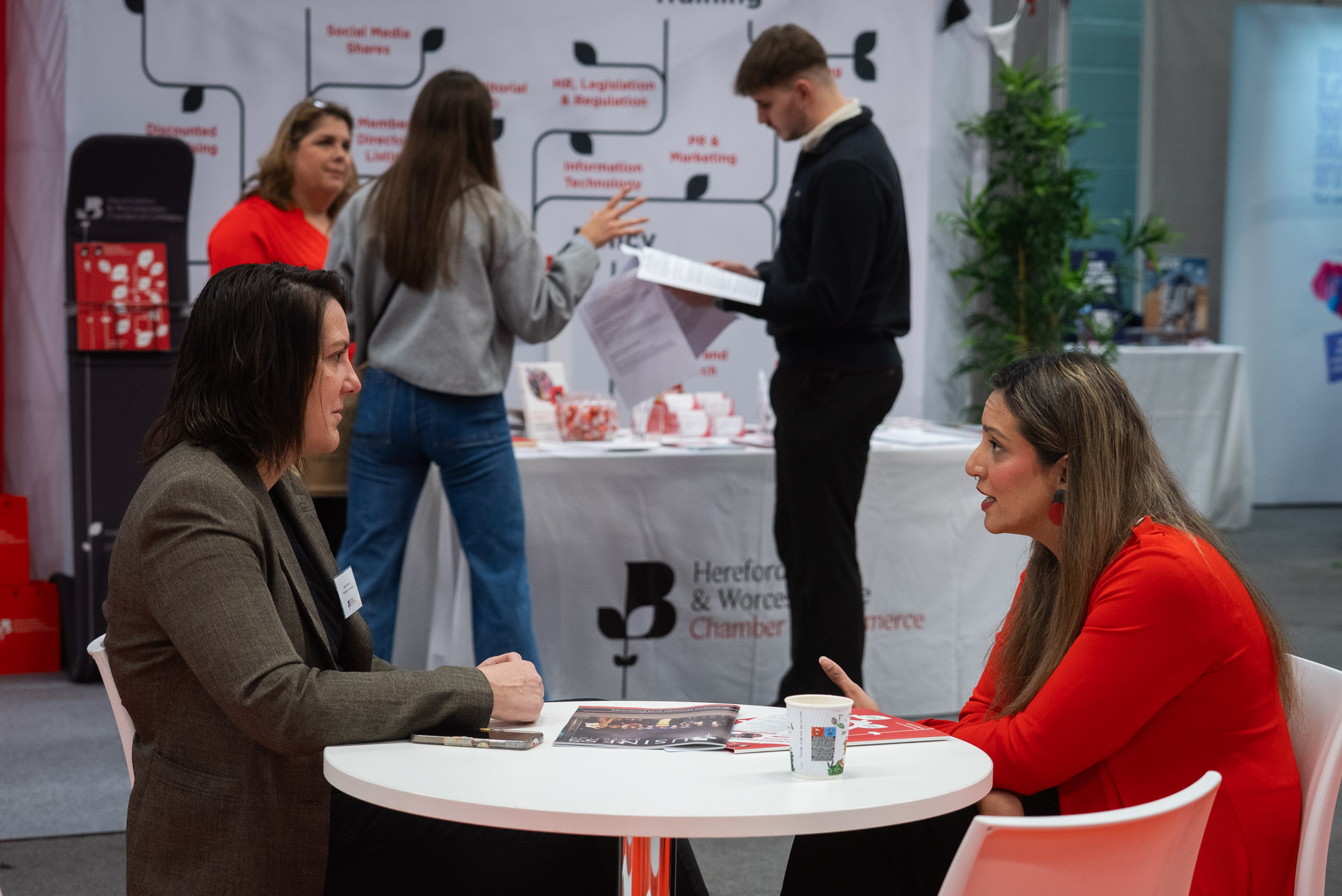 two men in building yard with hard hats, shaking hands
